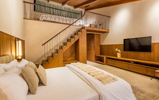 Attic suite at The Chestnut Grove, with a double-height ceiling and loft staircase